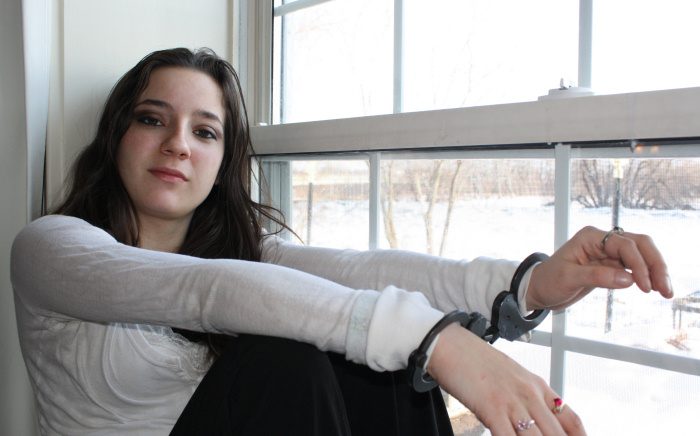 Kayla in black handcuffs
