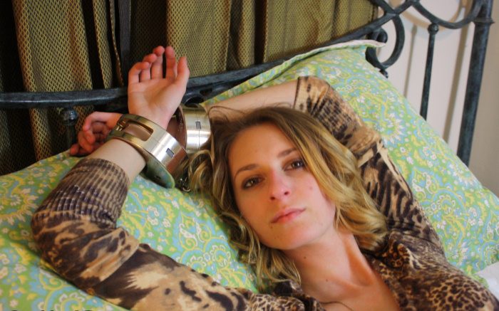 Anna in heavy handcuffs