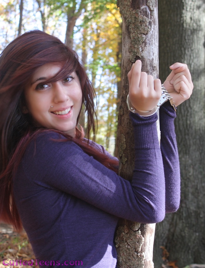 Cera cuffed to a tree