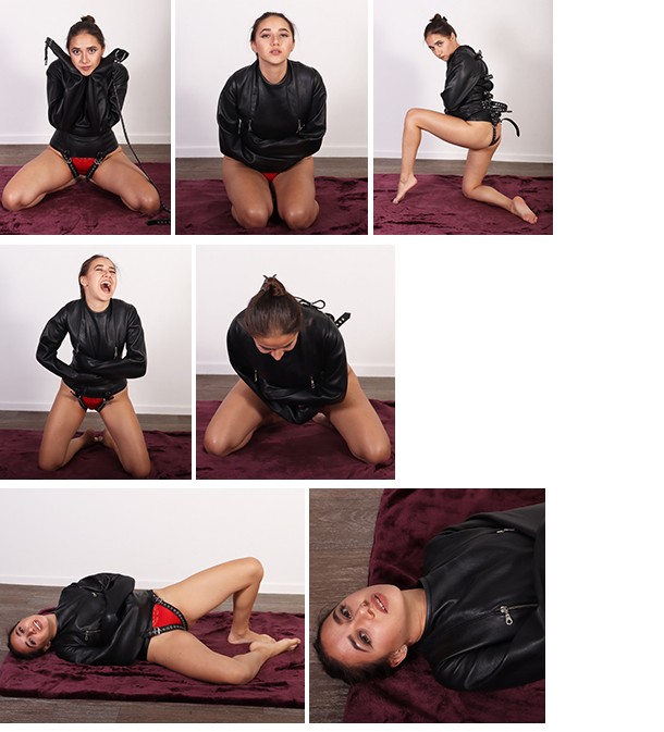 Emilia in a black leather straitjacket