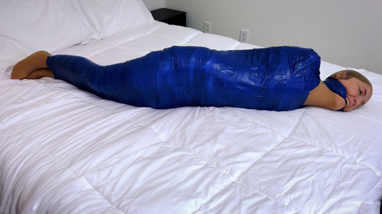 Rachel Adams Moans and Twists Under Inescapable Blue Tape Mummification