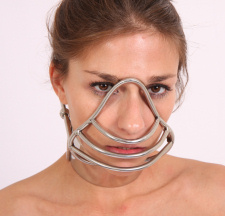 Romy is belted, clamped, and muzzled